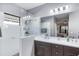 Double vanity bathroom with a large walk-in shower, modern finishes and fixtures at 12640 Coastal Breeze Way, Bradenton, FL 34211