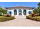 Community clubhouse with white exterior, blue shutters, and landscaping at 12640 Coastal Breeze Way, Bradenton, FL 34211