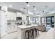 Modern kitchen with white cabinets, island, and stainless steel appliances at 12640 Coastal Breeze Way, Bradenton, FL 34211