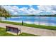 Serene lakeside walkway with bench, offering peaceful waterfront views at 12640 Coastal Breeze Way, Bradenton, FL 34211