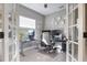 Home office with a standing desk, French doors and ample natural light at 12640 Coastal Breeze Way, Bradenton, FL 34211