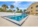 Community pool with lounge chairs and surrounding patio at 14459 River Beach Dr # 112, Port Charlotte, FL 33953