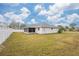 Large backyard with screened patio and grassy area at 1565 Piedmont Rd, Venice, FL 34293