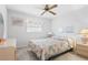 Bedroom with a queen bed, ceiling fan, and nightstand at 1565 Piedmont Rd, Venice, FL 34293