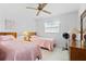 Guest bedroom with twin beds, ceiling fan, and dresser at 1565 Piedmont Rd, Venice, FL 34293