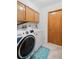 Convenient laundry room with washer, dryer, and ample storage at 1565 Piedmont Rd, Venice, FL 34293