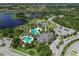 Aerial view of community with pools, park, and lake at 21205 Holmes Cir, Venice, FL 34293