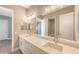 Double vanity bathroom with quartz countertop and gray tile at 21205 Holmes Cir, Venice, FL 34293