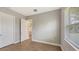 Bedroom with wood-look floors and access to hallway at 21205 Holmes Cir, Venice, FL 34293