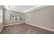 Bright bedroom featuring wood-look tile floors and multiple windows at 21205 Holmes Cir, Venice, FL 34293