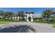 Community clubhouse exterior with palm trees and landscaping at 21205 Holmes Cir, Venice, FL 34293