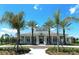 Community clubhouse with palm trees and landscaping at 21205 Holmes Cir, Venice, FL 34293