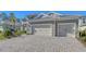 Brick paver driveway leading to a three-car garage at 21205 Holmes Cir, Venice, FL 34293