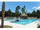 Community lap pool and leisure pool with thatched roof cabana at 21205 Holmes Cir, Venice, FL 34293