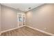 Sunlit office with French doors and wood-look tile floors at 21205 Holmes Cir, Venice, FL 34293