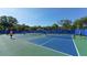 Multiple pickleball courts with blue fencing at 21205 Holmes Cir, Venice, FL 34293