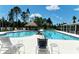 Community pool area with lounge chairs and umbrellas at 21205 Holmes Cir, Venice, FL 34293