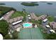 Aerial of condos near a swimming pool and tennis court with waterfront views and lush greenery at 4234 Gulf Of Mexico Dr # Y2, Longboat Key, FL 34228