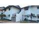 Front view of a light-colored building with stairs and landscaping at 4234 Gulf Of Mexico Dr # Y2, Longboat Key, FL 34228