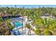 Aerial view of backyard featuring screened-in pool, lounge chairs, and lush tropical landscaping at 5341 Siesta Ct, Sarasota, FL 34242