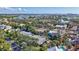 Aerial view of neighborhood showcasing lush tropical landscaping, and stunning panoramic water views on the horizon at 5341 Siesta Ct, Sarasota, FL 34242