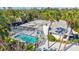 Aerial view of a backyard with a screened-in pool and surrounding lush tropical landscaping at 5341 Siesta Ct, Sarasota, FL 34242