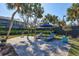 Lush backyard with patio, sun loungers and tropical landscaping at 5341 Siesta Ct, Sarasota, FL 34242