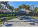 Spacious backyard with patio, sun loungers, grill and a tropical feel at 5341 Siesta Ct, Sarasota, FL 34242