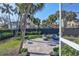 Landscaped backyard with patio, lawn, sun loungers and grill at 5341 Siesta Ct, Sarasota, FL 34242