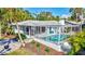 Rear exterior view of a house featuring an enclosed pool area and manicured landscaping at 5341 Siesta Ct, Sarasota, FL 34242