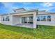 Covered patio with pavers, sliders, and grassy backyard at 8324 Golden Beach Ct, Parrish, FL 34219