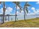 Peaceful waterfront view from a property with palm trees at 1750 Southpointe Dr, Sarasota, FL 34231