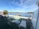 Waterfront backyard with patio furniture and private dock access at 23 Seaside Ct, Holmes Beach, FL 34217