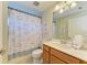 Bathroom with flamingo-themed decor and shower/tub combo at 6705 Grand Estuary Trl # 206, Bradenton, FL 34212