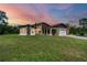 Stunning home boasts unique architectural details, stone accents, and a well-manicured lawn, creating a captivating curb appeal at 220 Ciboa Ave, North Port, FL 34287