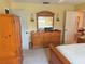 Bright bedroom with wood dresser and mirrored vanity at 390 301 W Blvd # 30B, Bradenton, FL 34205