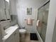 Clean bathroom with a shower/tub combo, white vanity, and tile floor at 5026 Calle Minorga, Sarasota, FL 34242