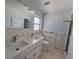 Updated bathroom with double vanity and walk-in shower at 1732 Boca Raton Ct, Punta Gorda, FL 33950