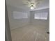 Bright bedroom with ceiling fan and large windows at 1732 Boca Raton Ct, Punta Gorda, FL 33950