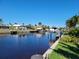 Scenic view of a canal with boats and lush landscaping at 1732 Boca Raton Ct, Punta Gorda, FL 33950