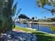 Peaceful canal-front view with lush landscaping and private dock at 1732 Boca Raton Ct, Punta Gorda, FL 33950