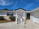 House exterior featuring a ramp, garage, and light-colored facade at 1732 Boca Raton Ct, Punta Gorda, FL 33950