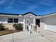 House exterior featuring a ramp, garage, and light-colored facade at 1732 Boca Raton Ct, Punta Gorda, FL 33950