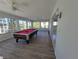 Game room with pool table and lots of natural light at 1732 Boca Raton Ct, Punta Gorda, FL 33950