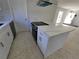 Kitchen island with white cabinets and quartz countertop at 1732 Boca Raton Ct, Punta Gorda, FL 33950