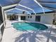 Inviting kidney-shaped pool with a screened enclosure at 1732 Boca Raton Ct, Punta Gorda, FL 33950