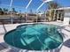 Relaxing kidney-shaped pool with screened enclosure at 1732 Boca Raton Ct, Punta Gorda, FL 33950