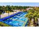 Aerial view of community pickleball courts surrounded by palm trees on a sunny day at 3028 Sky Blue Cv, Bradenton, FL 34211