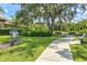 Community playground with mature trees, benches, and a walking path at 3028 Sky Blue Cv, Bradenton, FL 34211