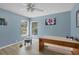 Sunny bedroom with a ceiling fan, two windows, and laminate flooring at 4918 Fallcrest Cir, Sarasota, FL 34233